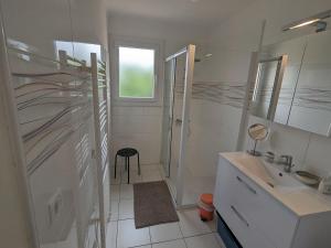 a white bathroom with a sink and a mirror at Entre Monts et Vermeille in Sorède +10 photos