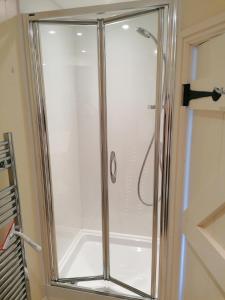 a shower with a glass door in a bathroom at The Prince of Wales in Helston
