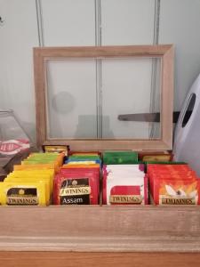 a bunch of different colored foods sitting on a shelf at The Prince of Wales in Helston