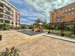 a playground with a slide and a swing at Cozy apartment Sunny Beach in Sunny Beach