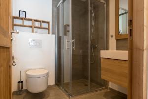 a bathroom with a toilet and a glass shower at Chalet Makalu in Les Gets +36 photos