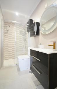 a bathroom with a toilet and a sink and a shower at Apartamento frente al mar en Cambados in Cambados