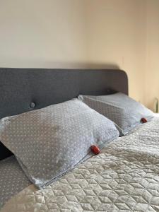 a bed with two pillows on top of it at Burgas Residence 712 in Burgas