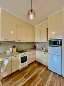 a kitchen with white appliances and wooden floors at Burgas Residence 712 in Burgas +26 photos
