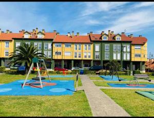 a playground in front of a large building at Coto Carcedo in Salinas