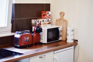 a kitchen counter with a microwave and a toaster at Lavender cozy & lovely 17 in Split