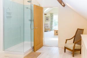 a bathroom with a shower with a glass door at Chater Barn in Leicester