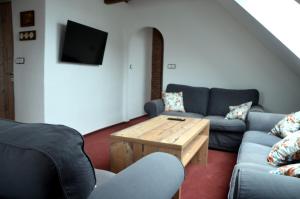 a living room with a couch and a coffee table at Penzion U Cyrila in Moravská Třebová