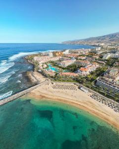 an aerial view of a beach and the ocean at Parque Santiago III Official in Playa de las Americas