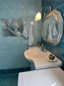 a bathroom with a sink and a mirror at Villa Palma in Skala Rachoniou