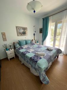 a bedroom with a bed with a quilt on it at Villa Palma in Skala Rachoniou