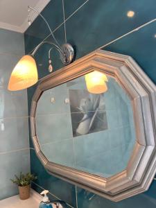 a mirror in a bathroom with a person in it at Villa Palma in Skala Rachoniou