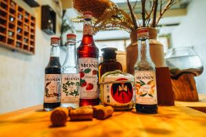 a group of bottles of alcohol sitting on a table at Backstage Party Hostel & Bar in Osaka