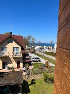 a view of a house with a yard at Baltic Vip Nowe Apartamenty blisko plaży in Rewal