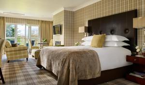 a bedroom with a large bed and a living room at The Killarney Park in Killarney