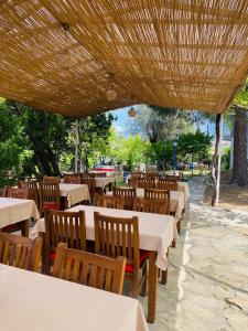 a row of tables and chairs in a restaurant at New Golden Gate Butik Otel in Muğla