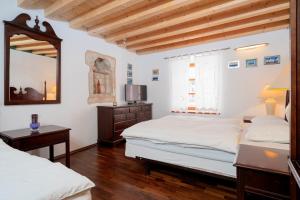 a bedroom with two beds and a mirror at Holiday Home Lavendula in Stari Grad
