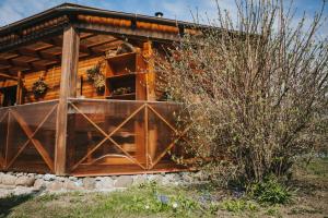 a cabin with a large wooden door and a bush at Sauna house in Daugavpils +15 photos