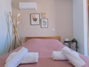a bedroom with a bed with two towels on it at STAY BelleVue Apartment in Khlorakas