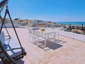a camera taking a picture of a table and chairs on a balcony at STAY BelleVue Apartment in Khlorakas
