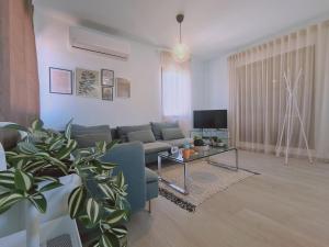 a living room with a couch and a table at STAY BelleVue Apartment in Khlorakas