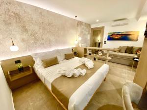 a bedroom with a large bed with towels on it at Meravigghia Suites Cefalù in Cefalù