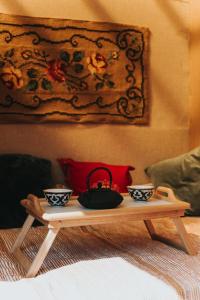 a coffee table with two cups on top of a bed at Sauna house in Daugavpils