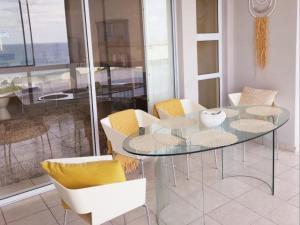 a dining room with a glass table and chairs at 1 St Daniel in Ramsgate