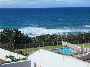 a view of a swimming pool and the ocean at 1 St Daniel in Ramsgate