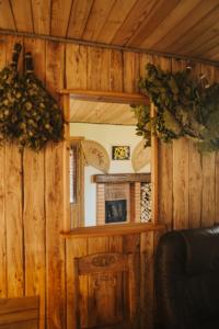 a room with a mirror in a wooden wall at Sauna house in Daugavpils