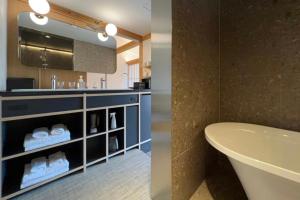 a bathroom with a sink and a toilet and a tub at Kyoto ITOYA Hotel Mon in Kyoto +27 photos