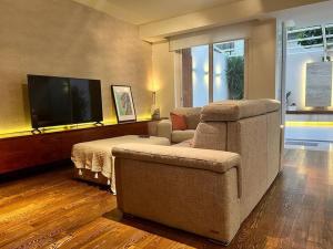 a living room with a couch and a television at Pembroke St Julians Luxury, Comfort, Location in Pembroke
