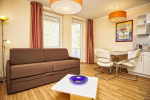 ein Wohnzimmer mit einer Couch und einem Tisch in der Unterkunft strandnah, Balkon, AHOI Erlebnisbad gratis in Sellin - Strandresidenz Brandenburg FeWo 14 in Göhren