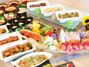 a table filled with different types of food in trays at LiVEMAX RESORT Kinugawa in Nikko
