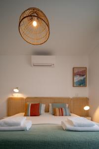 カバナス・デ・タビラにあるCasa Cabanas - Cabanas Gardensのベッドルーム1室(ベッド2台、シャンデリア付)