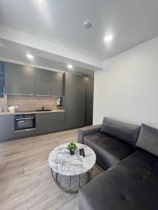a living room with a couch and a table at Apartamentai Sandra in Klaipėda