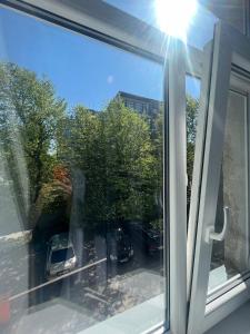 a window with a view of a car on a street at Apartamentai Sandra in Klaipėda