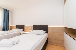 Postel nebo postele na pokoji v ubytování Superior Family Apartment Loti