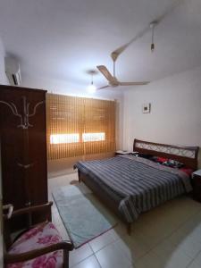 a bedroom with a bed and a chair and a window at Sweet aqaba apartment in Aqaba