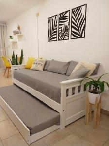 a bed in a living room with a couch at NUEVA CORDOBA Apartamento ILLIA, Excelente ubicación!!! in Córdoba