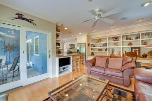 a living room with a couch and a table at Lovely Phoenix Vacation Rental Home with Pool! in Phoenix