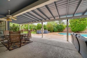 a patio with a table and chairs and a pool at Lovely Phoenix Vacation Rental Home with Pool! in Phoenix