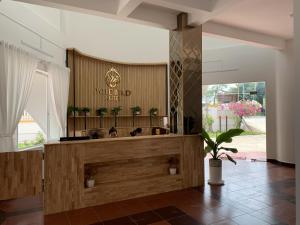 a lobby with a counter with plants on it at Wildbird Hotel in Tràm Chim