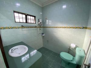 a bathroom with a sink and a toilet at Happiness Homestay in Mersing