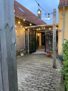 an entrance to a building with lights on it at Room 19 - Hawkraft kulturhotel in Vestervig