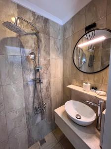 a bathroom with a shower and a toilet and a sink at Galley Hotel in Istanbul