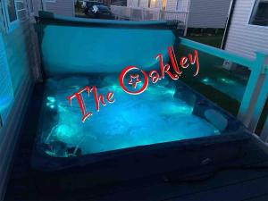 a hot tub with a sign that reads the cavity at Tattershall Lakes The Oakley Caravan 8 berth, Hot tub & WiFi in Tattershall