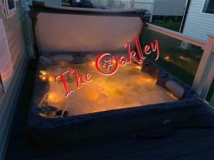 a jacuzzi tub with a sign that says the okay at Tattershall Lakes The Oakley Caravan 8 berth, Hot tub & WiFi in Tattershall