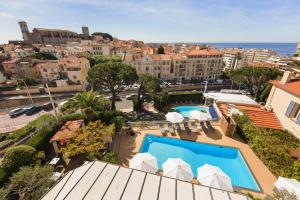 arial view of a hotel with a pool and buildings at Best Western Hôtel des Orangers Cannes in Cannes