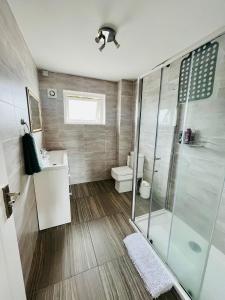 a bathroom with a shower and a sink and a toilet at BEA Allenby Walk in Manchester